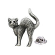 Antique silver-coloured cat lapel pin badge with arched back, raised tail and butterfly clasp