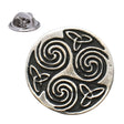Antique silver-coloured circular Celtic triskele lapel pin with three spiral motifs, knotwork and butterfly clasp