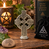Illustrative in-situ display of a Celtic Cross pewter ornament on rustic wooden shelf with lit candle, ivy, amethyst and gift pouch