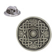 Antique silver-coloured circular Celtic shield lapel pin with four knotwork motifs, raised centre and butterfly clasp