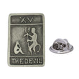 Antique silver-coloured The Devil tarot card XV lapel pin featuring horned figure, lettering and butterfly clasp