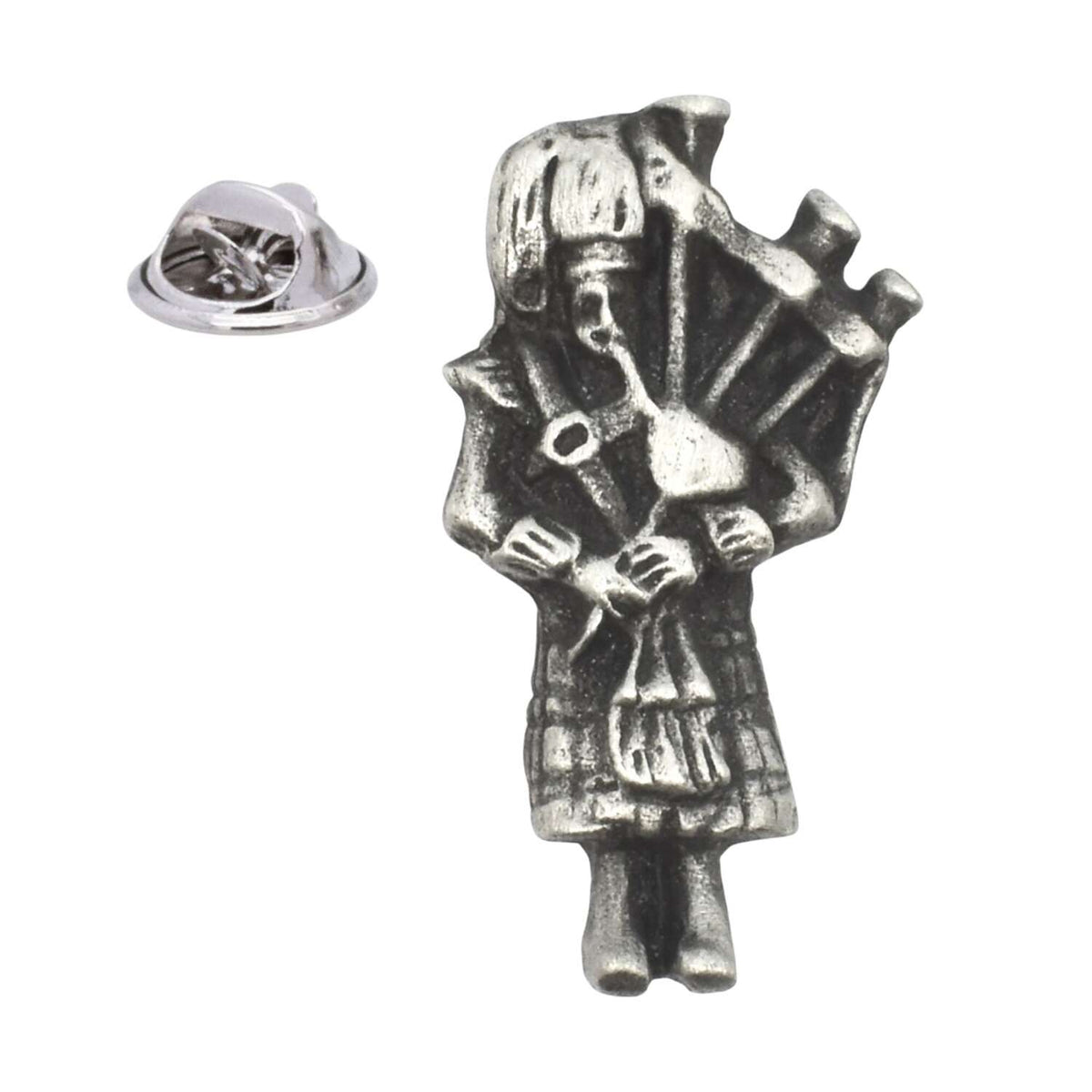 Antique silver-coloured Scottish bagpiper in Highland dress playing bagpipes, lapel pin with butterfly clasp