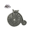 Antique silver pewter penny farthing bicycle lapel pin with large spoked front wheel, small rear wheel and butterfly clasp