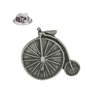 Antique silver pewter penny farthing bicycle lapel pin with large spoked front wheel, small rear wheel and butterfly clasp