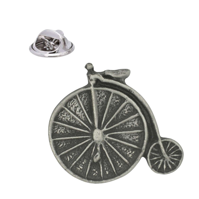 Antique silver pewter penny farthing bicycle lapel pin with large spoked front wheel, small rear wheel and butterfly clasp