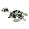 Artist's palette pewter lapel pin badge with paint wells and crossed paintbrushes, pictured with butterfly clasp