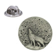 Circular pewter lapel pin showing a howling wolf silhouetted against a cratered full moon, with butterfly clasp