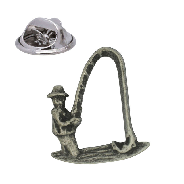 Pewter fishing lapel pin badge depicting an angler holding a curved fishing rod, with butterfly clasp
